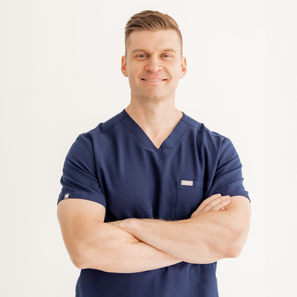 The image shows a dentist smiling at a patient with a mirror, reflecting their reflection back at them.