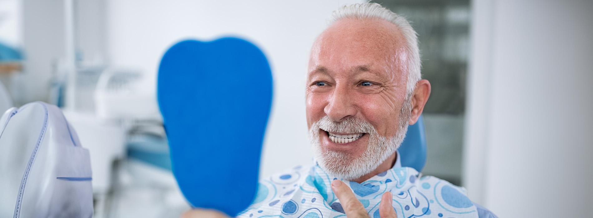 A well-lit reception area with a desk, computer monitor, and potted plant.